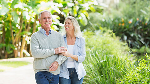 Senior man and senior woman walking outdoors in a park in Winter Garden, Florida